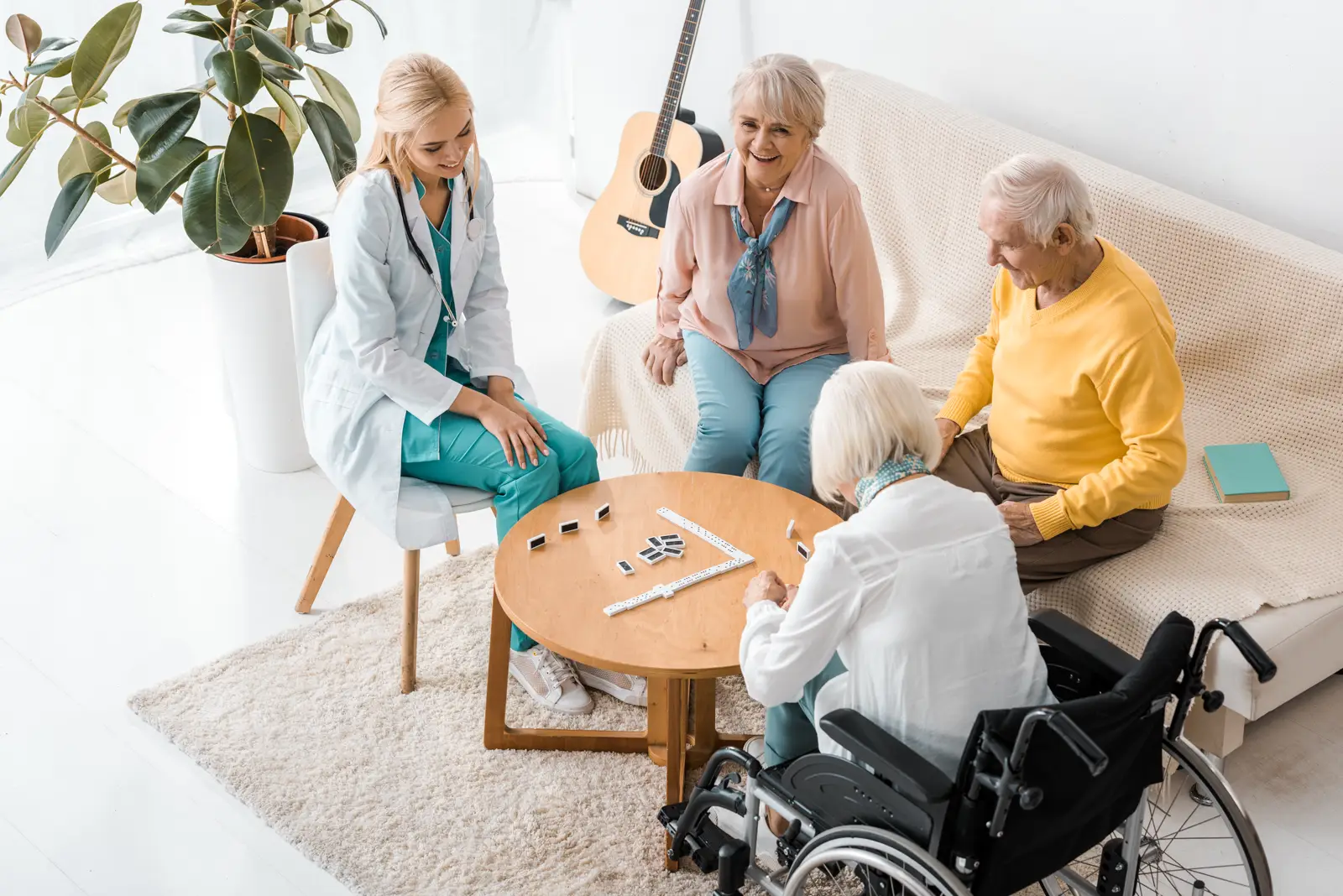 A support worker playing a game with a group of residents