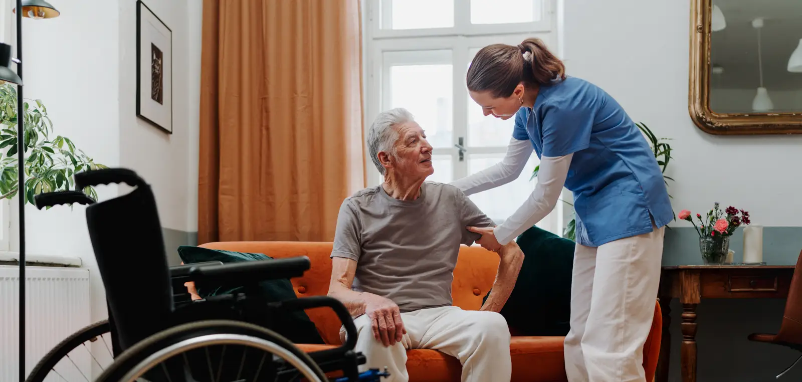 A support worker helping an older man at home