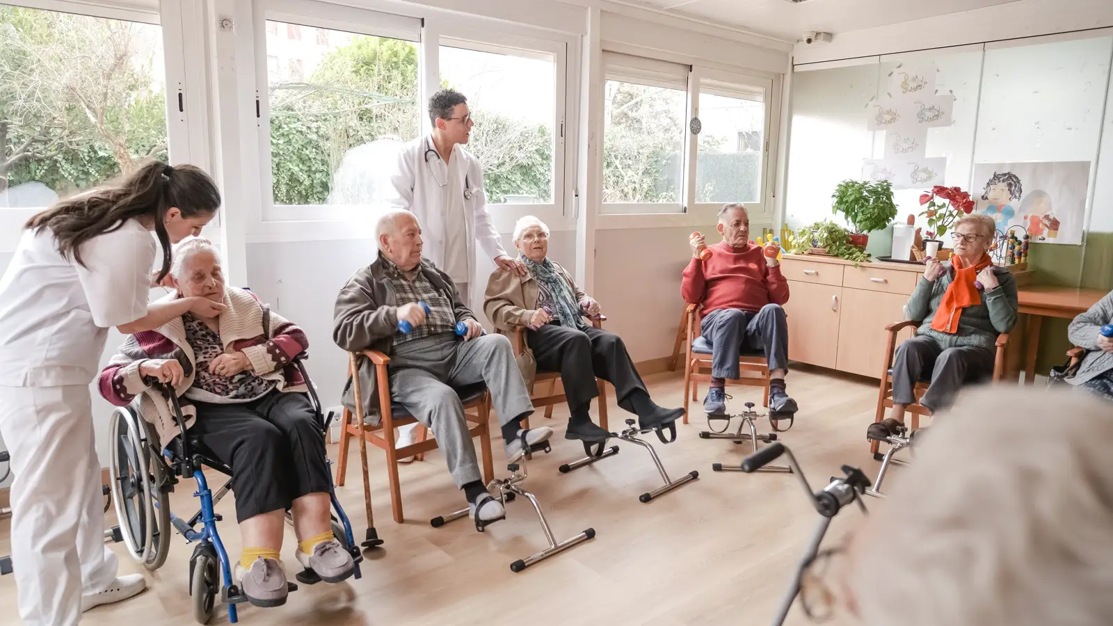 An allied health professional working with two residents