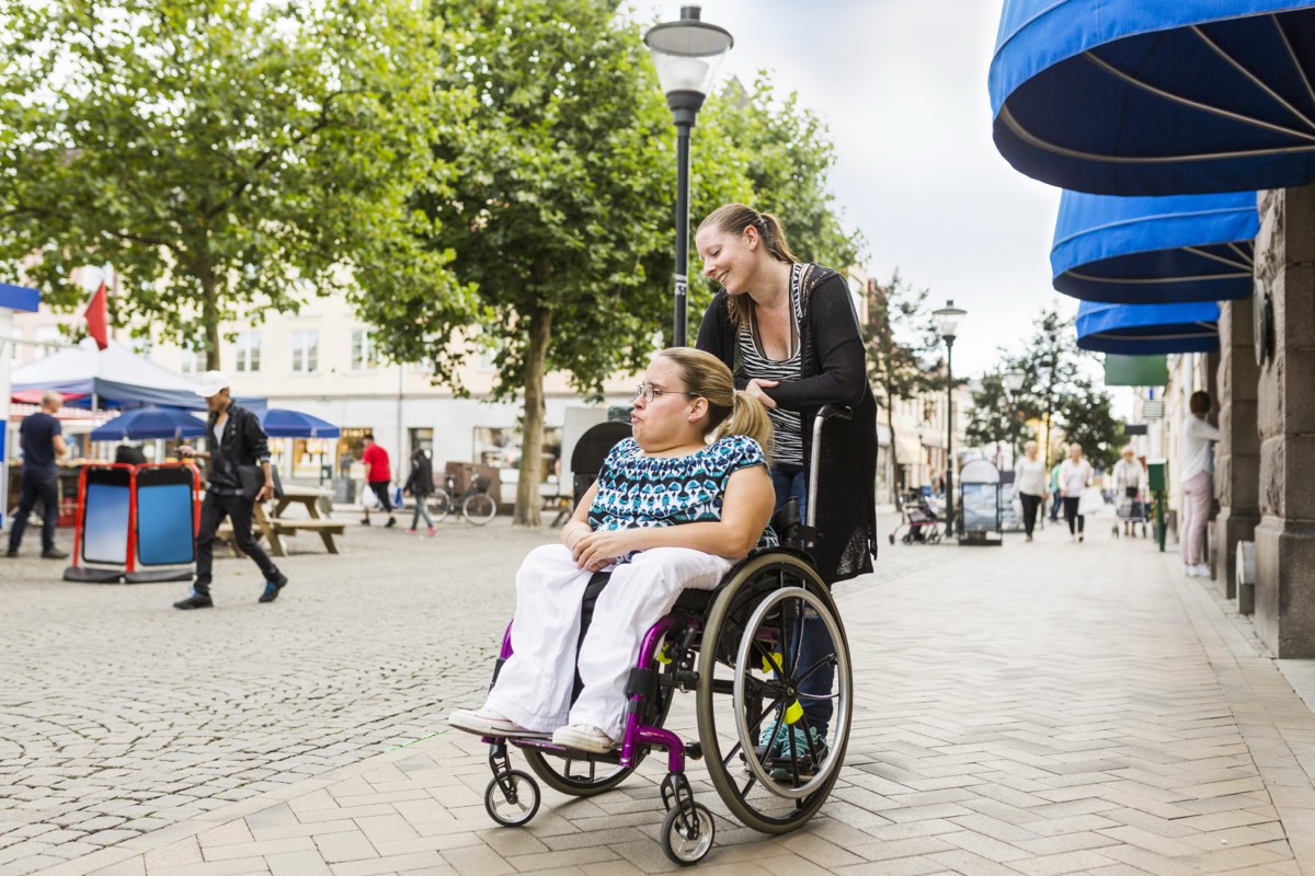 A group on a community outing, one member using a wheelchair