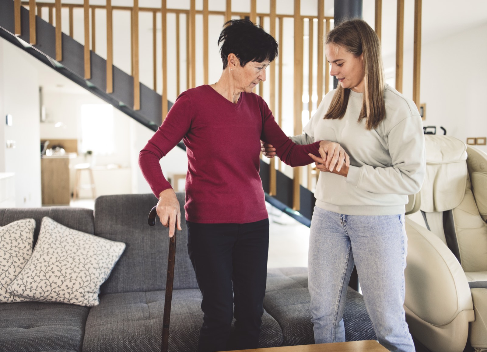 A support worker and a client walking together outdoors